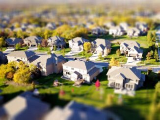 Bright, sunny view of a residential neighborhood in Castle Rock, Colorado, with modern homes in the foreground, representi...