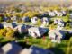 Bright, sunny view of a residential neighborhood in Castle Rock, Colorado, with modern homes in the foreground, representi...