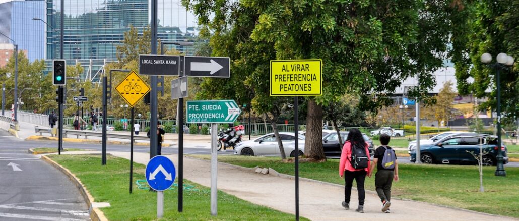 Professionally dressed person stands at a fork in a path, contemplating which direction to take, symbolizing the choice be...