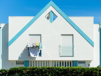 Exterior view of a modern single-family home in Denver, Colorado under a bright, clear sky, representing the local real es...