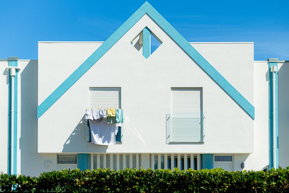 Exterior view of a modern single-family home in Denver, Colorado under a bright, clear sky, representing the local real es...
